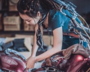 photo of woman repairing motorcycle